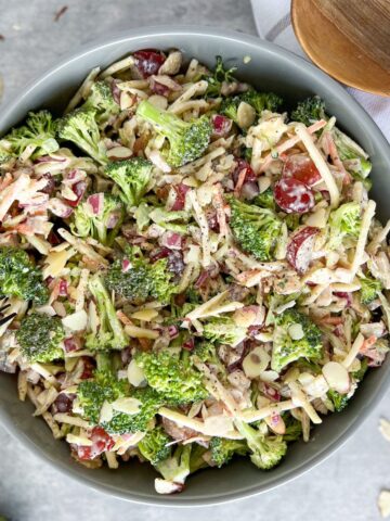 Whole30 Broccoli Salad in a bowl with wood spoons