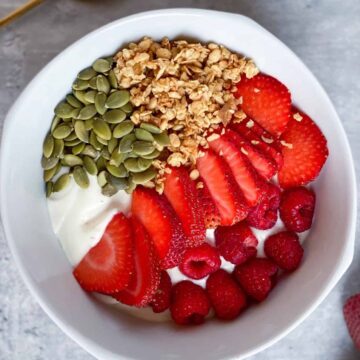 Dairy-free yogurt parfait with strawberries, raspberries, granola and pumpkin seeds
