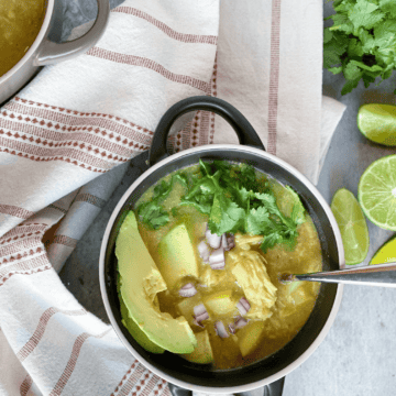 Instant Pot White Chicken Chili in a bowl topped with avocado slices and cilantro