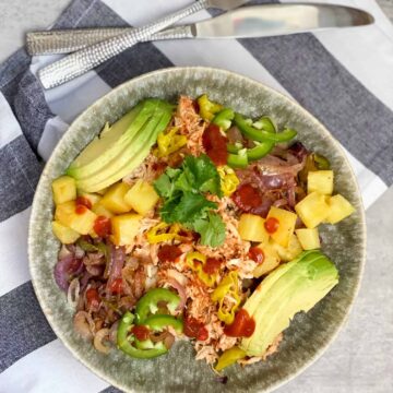 BBQ chicken bowl with avocado, onions, pineapple and jalapenos in a bowl