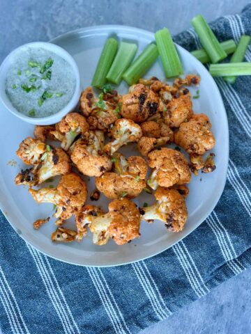 Buffalo Cauliflower on a plate with ranch and celery