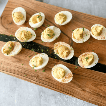 healthy deviled eggs on a wood plank