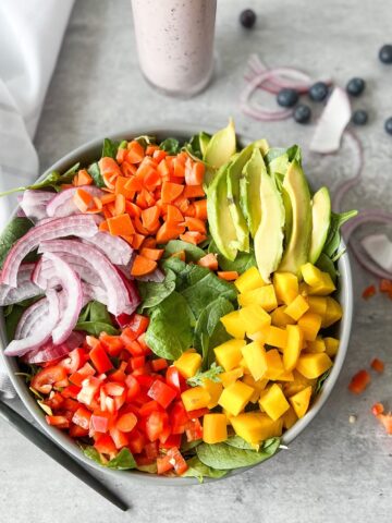 a rainbow crunch salad with lots of colorful veggies in a bowl.
