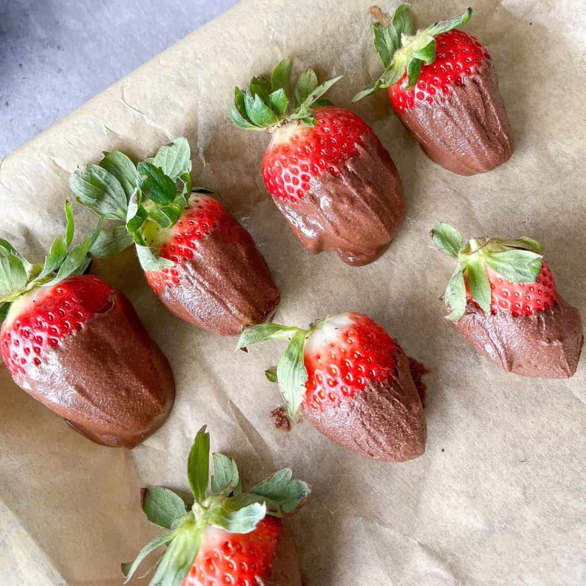 Healthy Chocolate Covered Strawberries on parchment paper